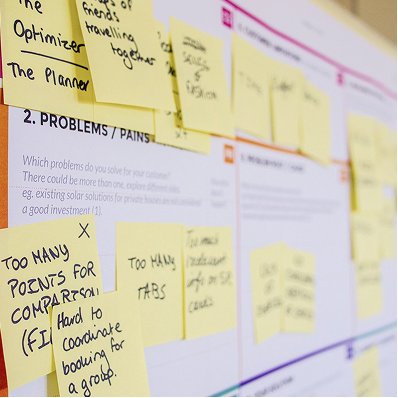 A stack of labelled project folders and notebooks